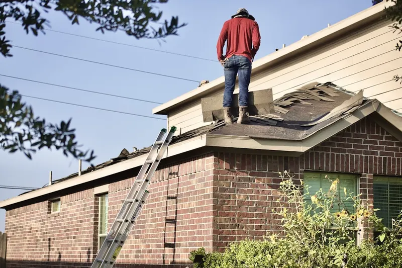 Professional roofer working on a residential roof in Twin Creeks